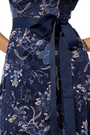 A model wearing the Loren Lace Midi Dress in colour Navypink (Blue), from the front, cropped image