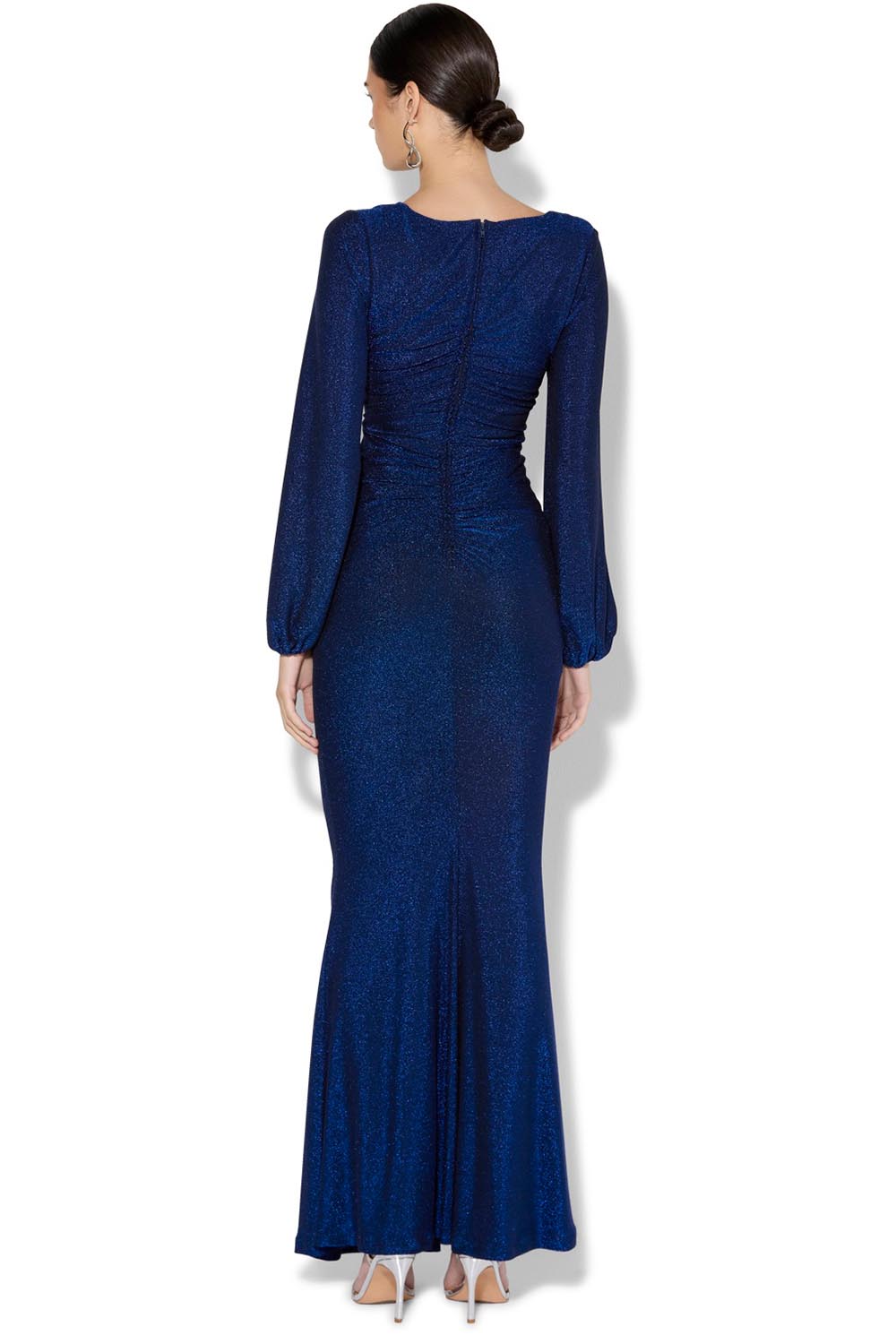 A model wearing the Serena Shimmer Maxi Gown in colour Sapphire (Blue), from the back