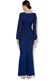 A model wearing the Serena Shimmer Maxi Gown in colour Sapphire (Blue), from the back