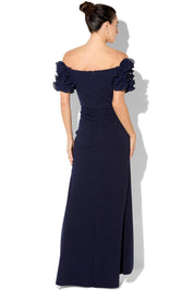 A model wearing the Diana Ruffle Sleeve Gown in colour Navy (Blue), from the back