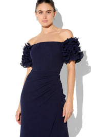A model wearing the Diana Ruffle Sleeve Gown in colour Navy (Blue), from the front, cropped image