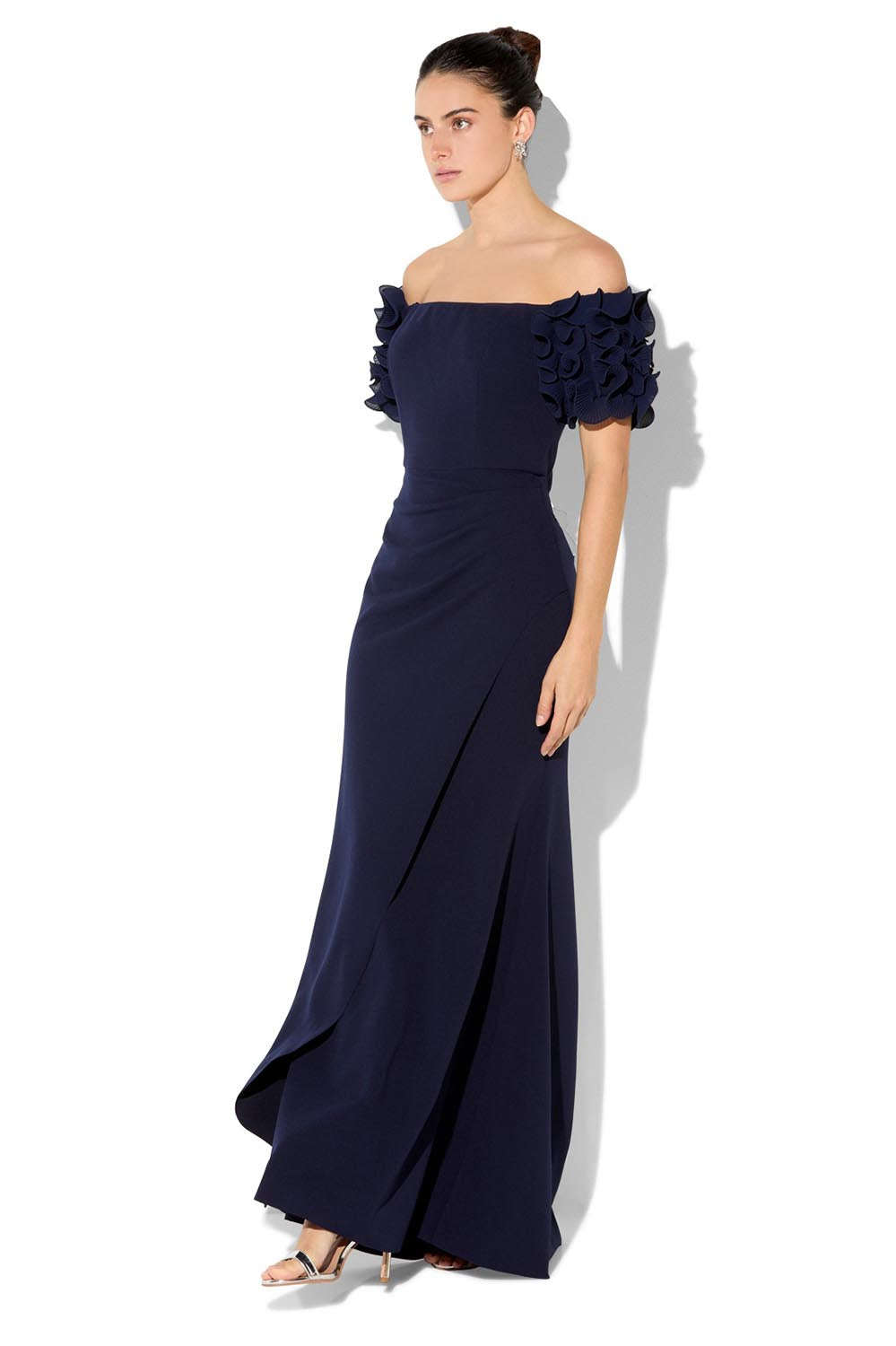 A model wearing the Diana Ruffle Sleeve Gown in colour Navy (Blue), from the front, showing the whole outfit