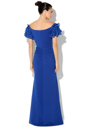 A model wearing the Diana Ruffle Sleeve Gown in colour Sapphire (Blue), from the back