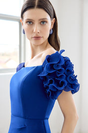 A model wearing the Diana Ruffle Sleeve Gown in colour Sapphire (Blue), from the front, cropped image