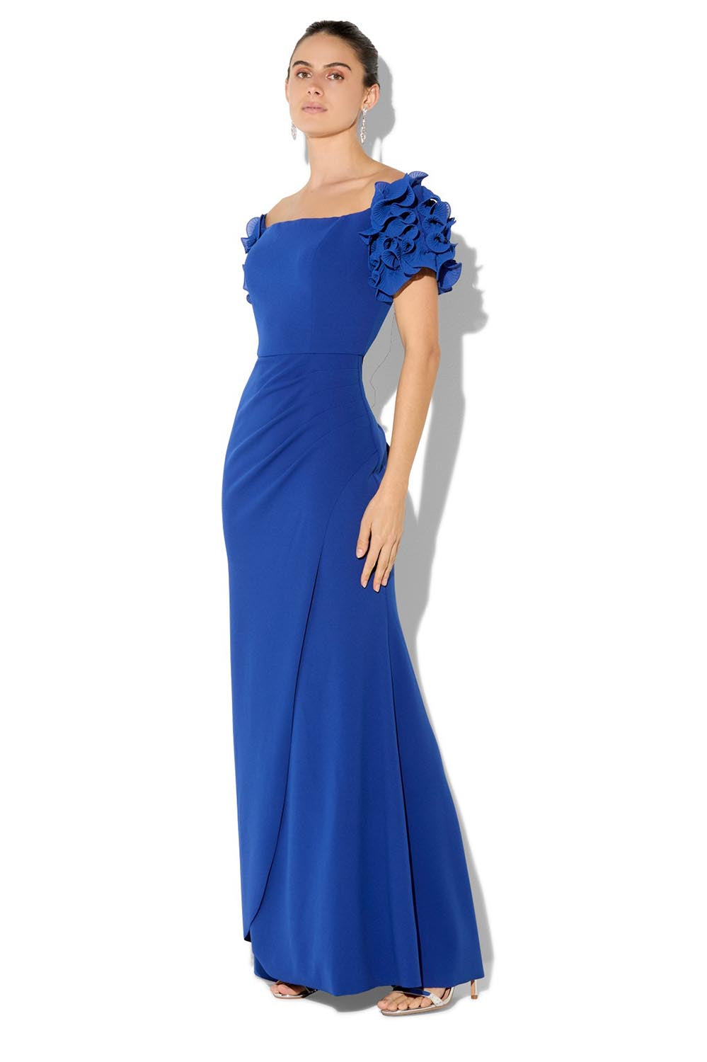 A model wearing the Diana Ruffle Sleeve Gown in colour Sapphire (Blue), from the front, showing the whole outfit