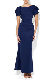 A model wearing the Monet Rosette Sleeve Gown in colour Navy (Blue), from the front, cropped image