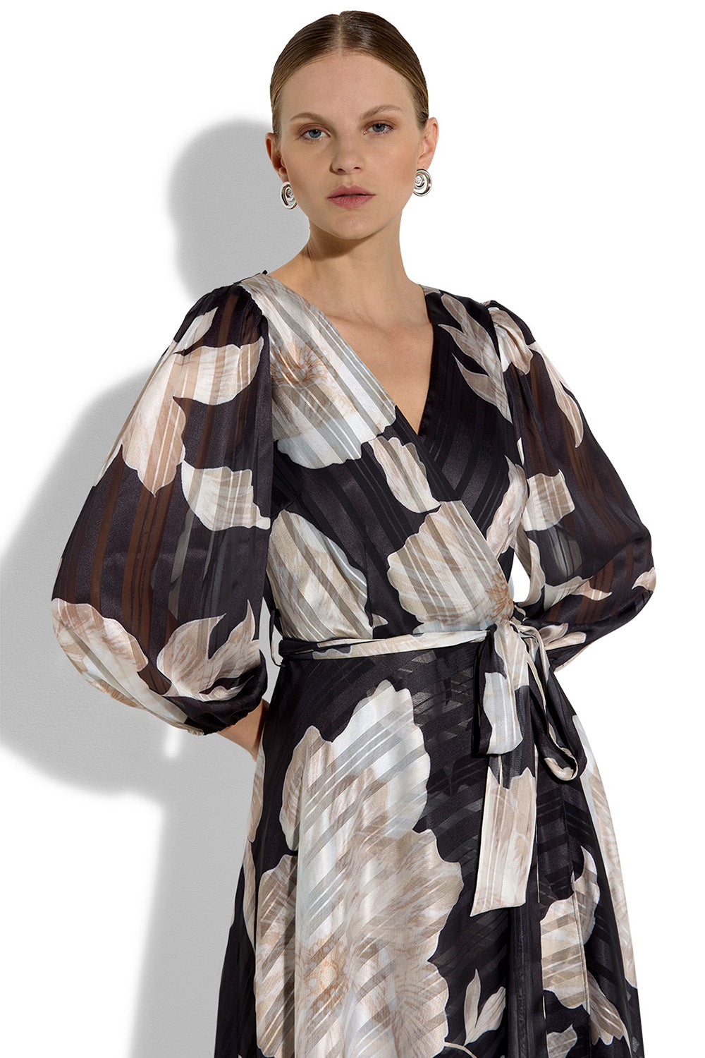 A model wearing the Soraya Printed Maxi Dress in colour Blackprint (Black), from the front, cropped image