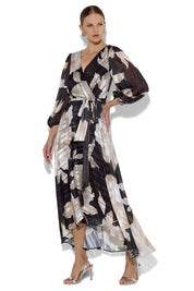 A model wearing the Soraya Printed Maxi Dress in colour Blackprint (Black), from the front, showing the whole outfit
