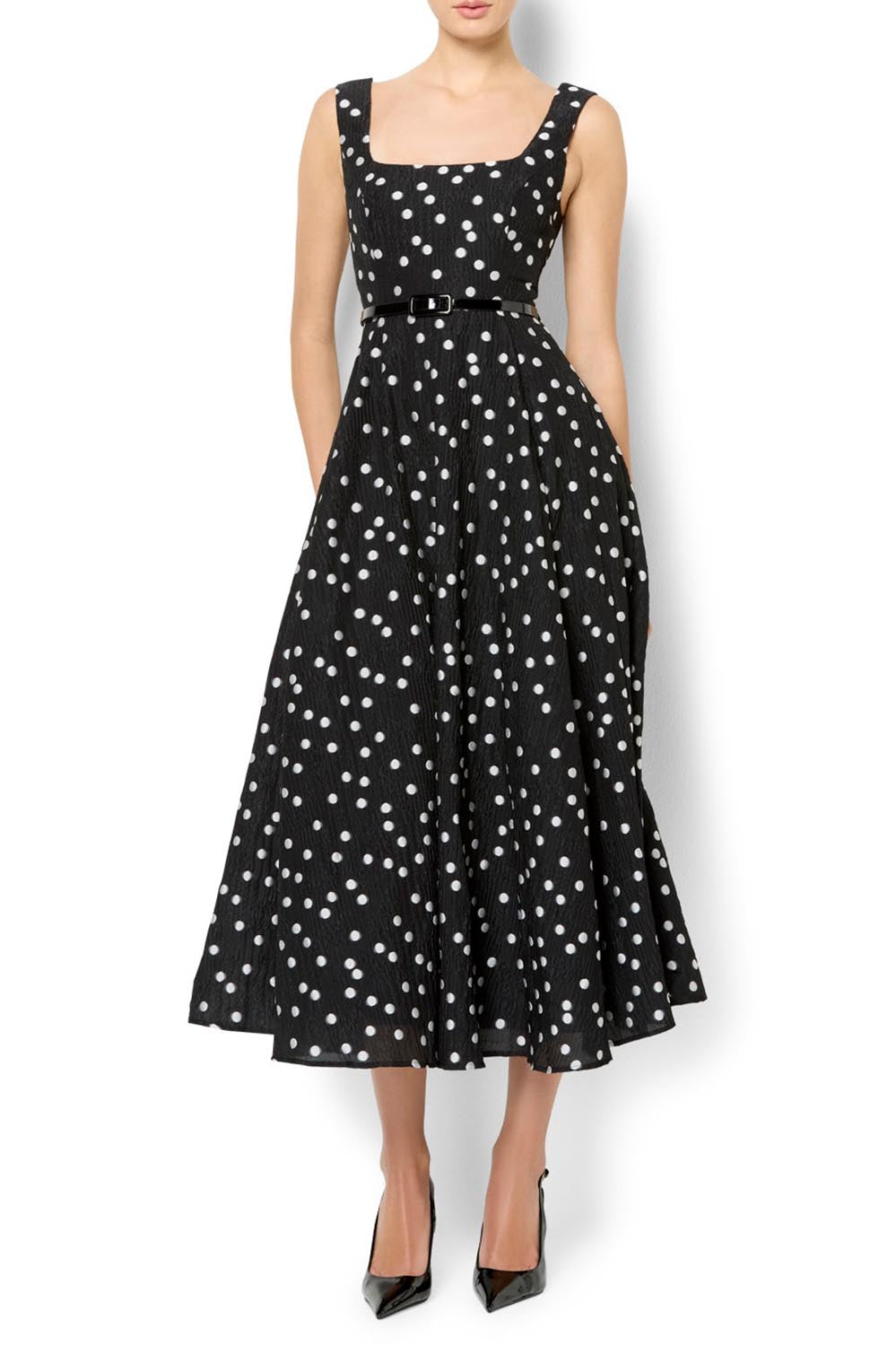 A model wearing the Ascot Dot Dress in colour Blkwhtdot (Black), from the front, cropped image