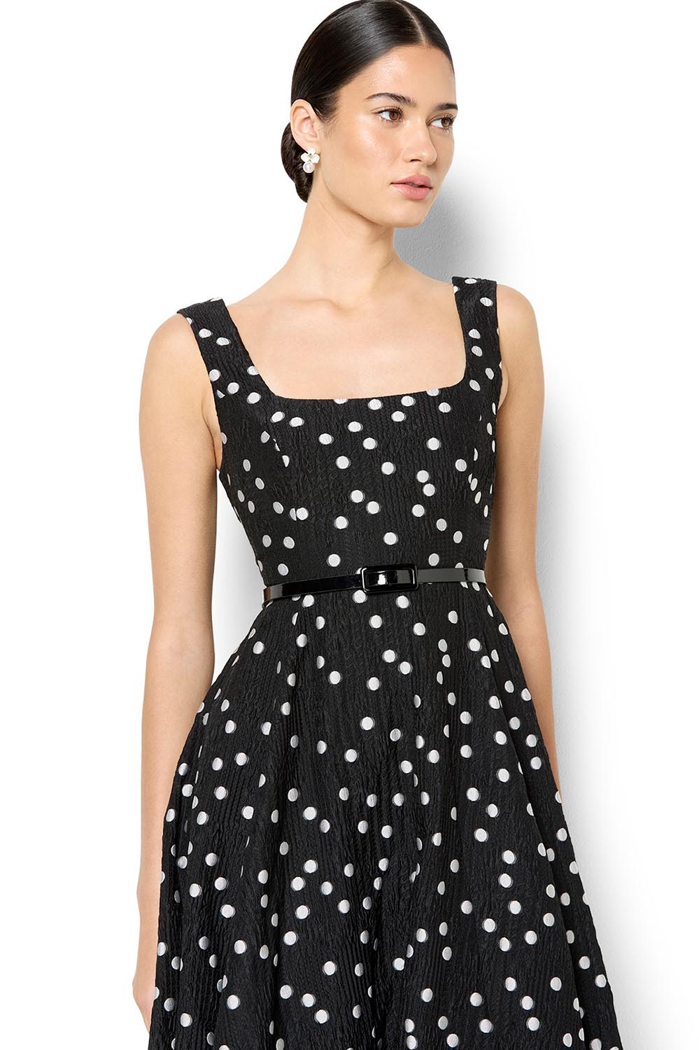A model wearing the Ascot Dot Dress in colour Blkwhtdot (Black), from the front, cropped image