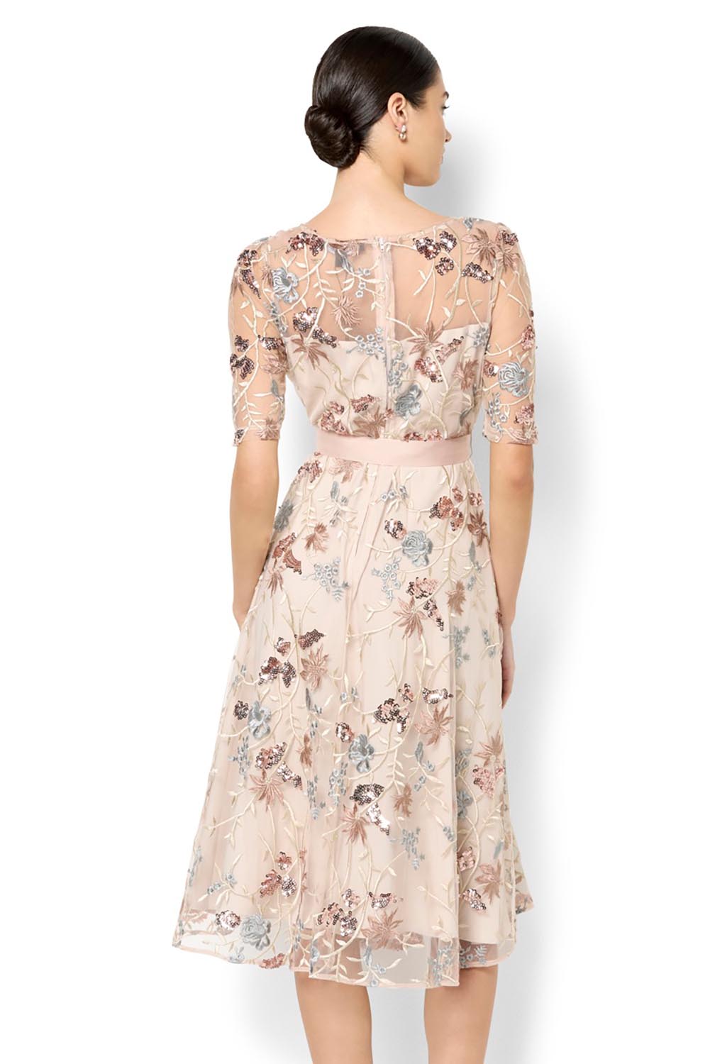 A model wearing the Pippa Embroidered Dress in colour Mink (Pink), from the back