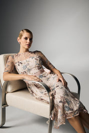 A model wearing the Pippa Embroidered Dress in colour Mink (Pink), from the front, showing the whole outfit