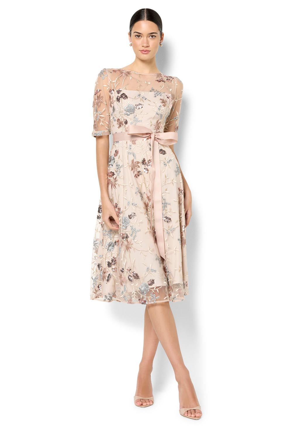 A model wearing the Pippa Embroidered Dress in colour Mink (Pink), from the front, showing the whole outfit