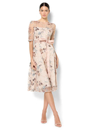 A model wearing the Pippa Embroidered Dress in colour Mink (Pink), from the front, showing the whole outfit