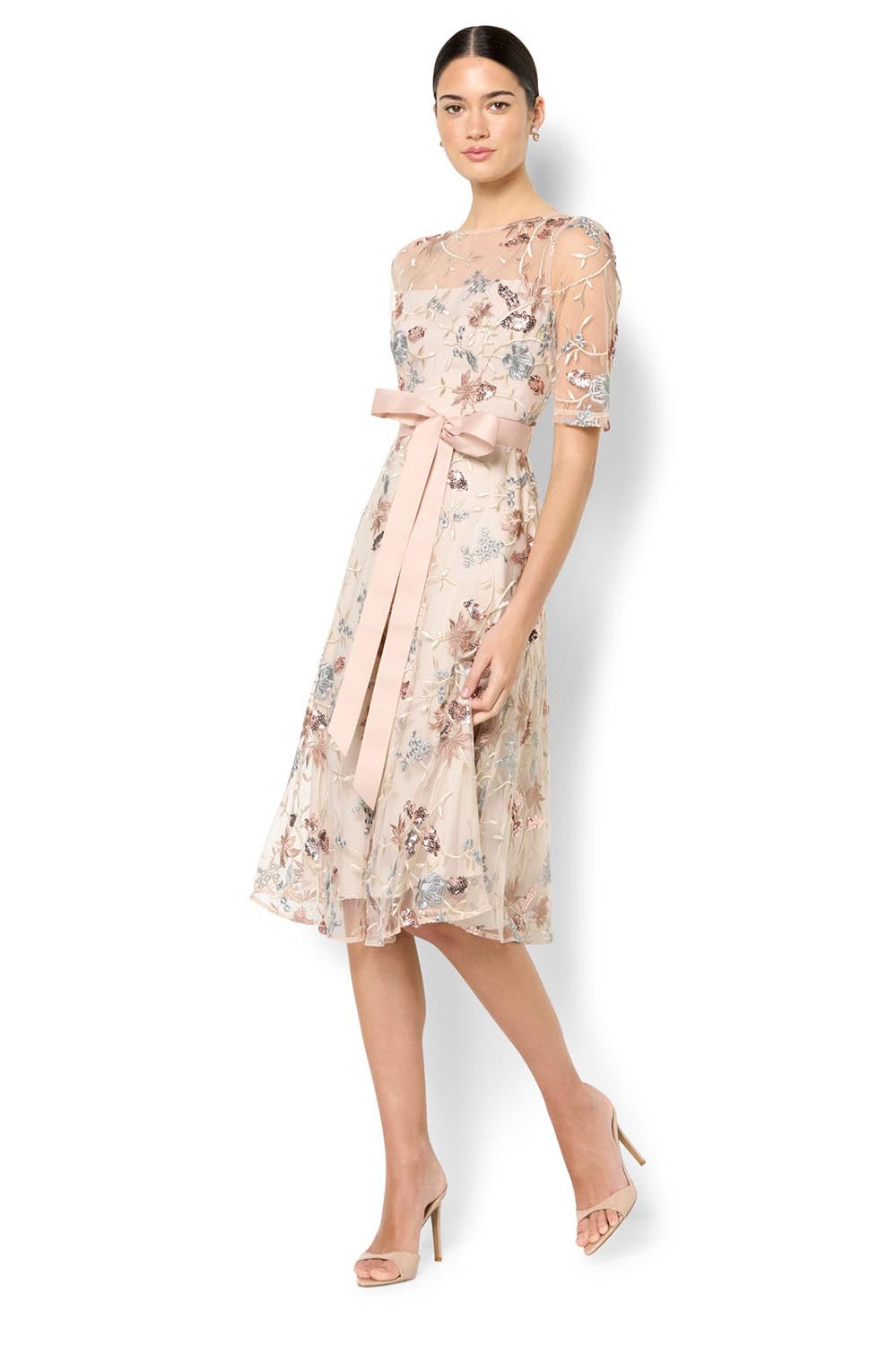 A model wearing the Pippa Embroidered Dress in colour Mink (Pink), from the front, showing the whole outfit