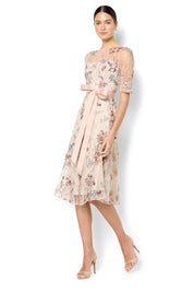 A model wearing the Pippa Embroidered Dress in colour Mink (Pink), from the front, showing the whole outfit