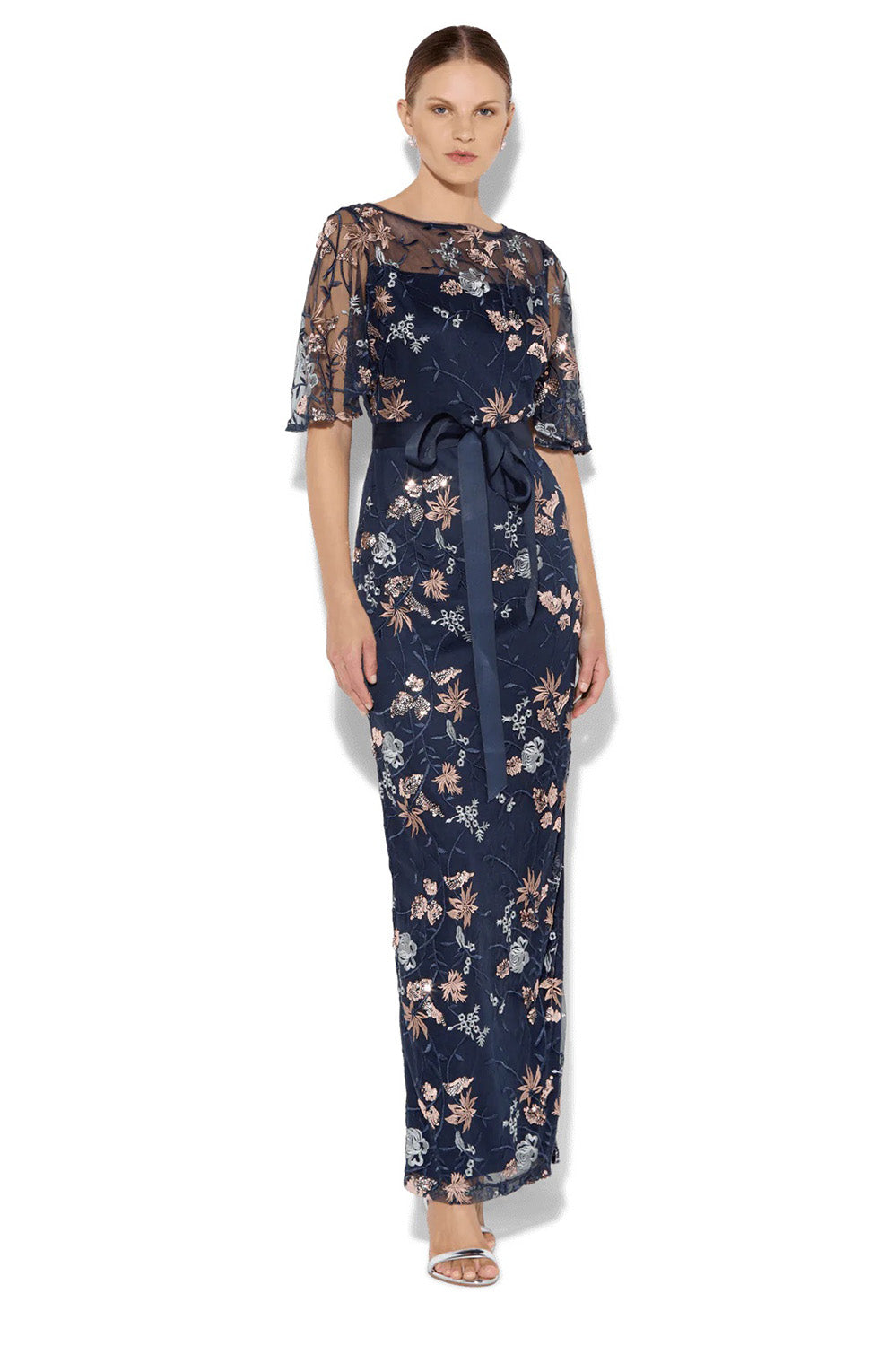 A model wearing the Florence Navy Embroidered Gown in colour Navy (Blue), from the front, showing the whole outfit
