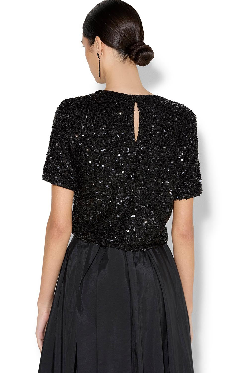 A model wearing the Ginger Sequin Top in colour Black (Black), from the back