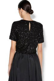 A model wearing the Ginger Sequin Top in colour Black (Black), from the back