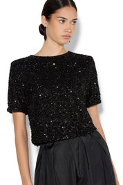 A model wearing the Ginger Sequin Top in colour Black (Black), from the front, cropped image