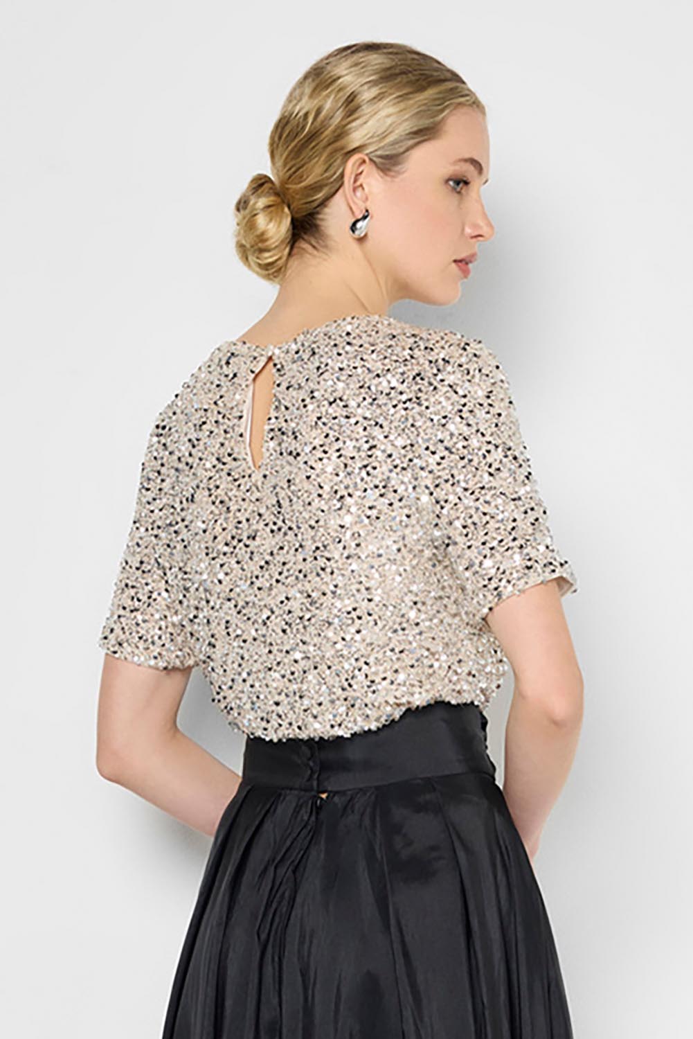 Model Genericm wearing size sample of the Ginger Sequin Top - Mink in colour Mink, from an angle