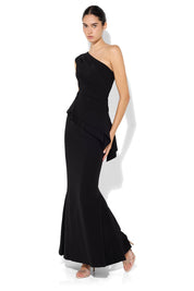 A model wearing the Oscar One Shoulder Gown in colour Black (Black), from the front, showing the whole outfit