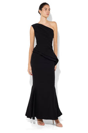 A model wearing the Oscar One Shoulder Gown in colour Black (Black), from the front, showing the whole outfit