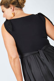 Model Fiona wearing size 16 of the Chloe Dress in colour Black (Black), from the back