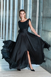 Model Nathalie wearing size 8 of the Chloe Dress in colour Black (Black), from the front, showing the whole outfit