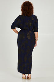 Model Maddy wearing size 16 of The Printed Nadine Dress in colour Navygold (Blue), from the back