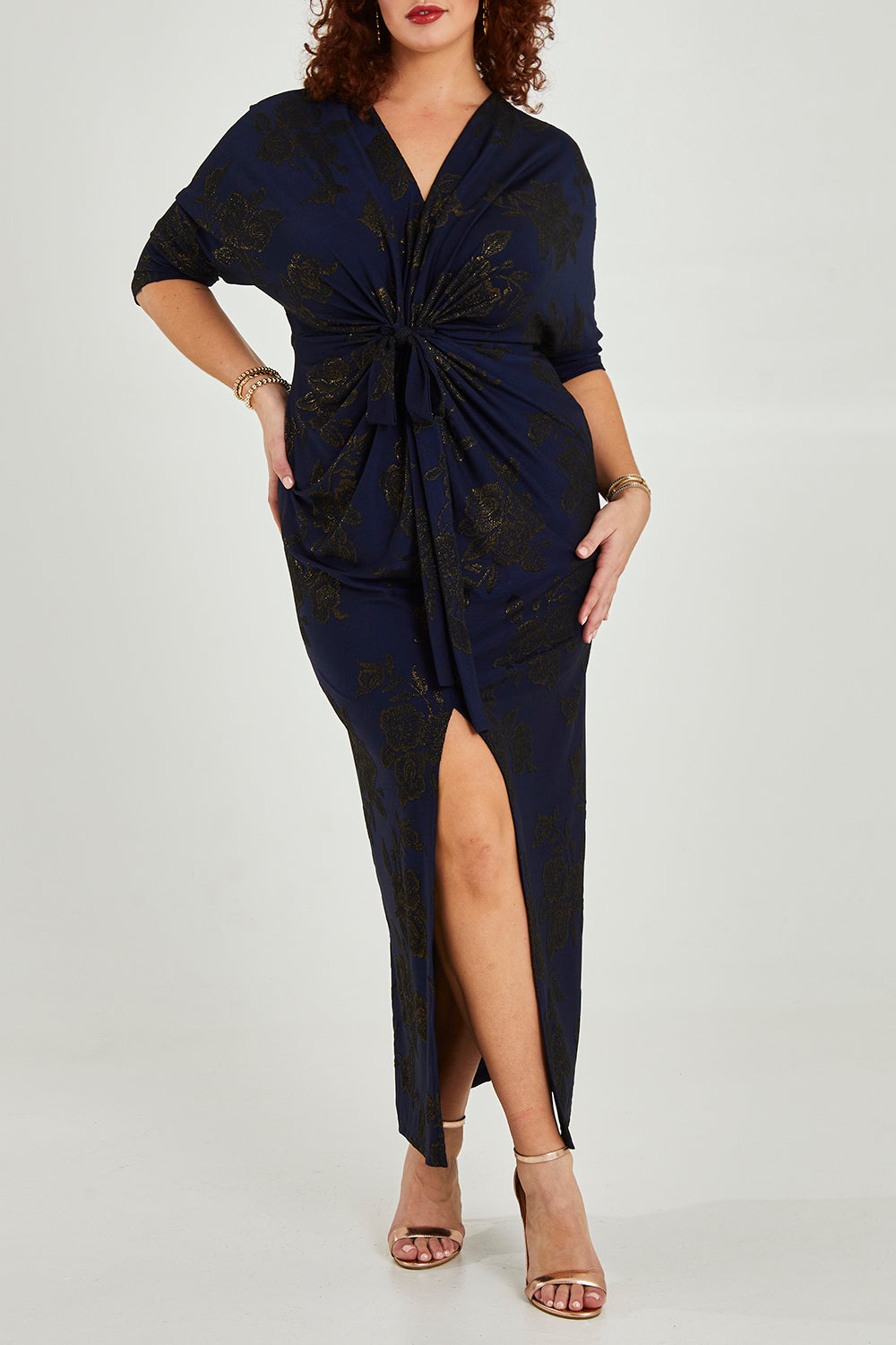 Model Maddy wearing size 16 of The Printed Nadine Dress in colour Navygold (Blue), from the front, cropped image