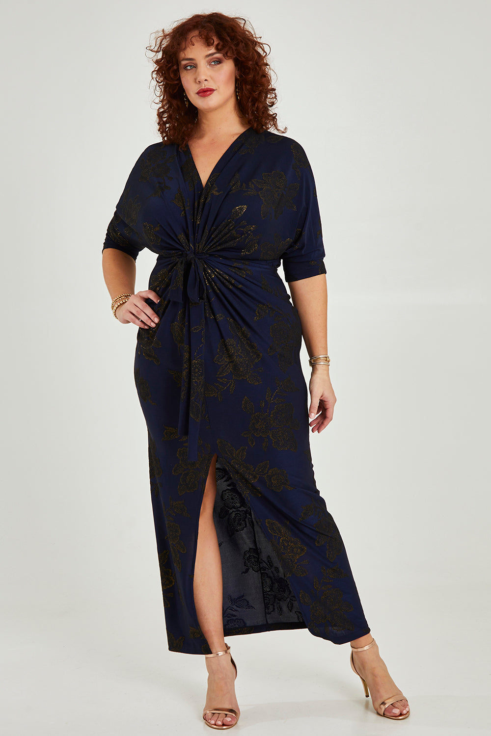 Model Maddy wearing size 16 of The Printed Nadine Dress in colour Navygold (Blue), from the front, showing the whole outfit