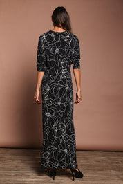 Model Amanda wearing size 10 of The Printed Nadine Dress in colour Magnolia (Black), from the back