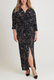 Model Chanel wearing size 16 of The Printed Nadine Dress in colour Magnolia (Black), from the front, cropped image