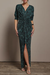 Model Madeline wearing size 10 of The Printed Nadine Dress in colour Jadebling (Green), from the front, cropped image