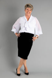 A model wearing size 8 of the Roanna Skirt in colour Black (Black), from the front, showing the whole outfit