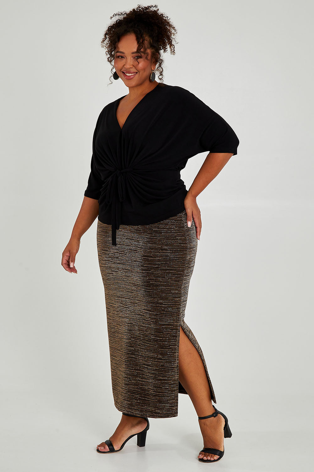 Model Alexis wearing size 18 of the Kate Skirt in colour Copper (Metallics), from the front, showing the whole outfit