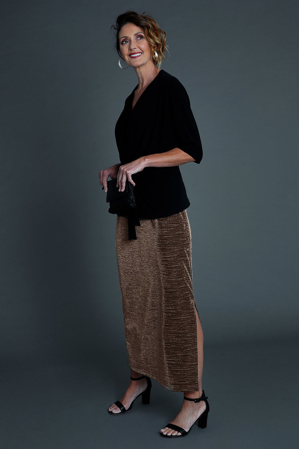 Model Emma wearing size 10 of the Kate Skirt in colour Copper (Metallics), from the front, showing the whole outfit