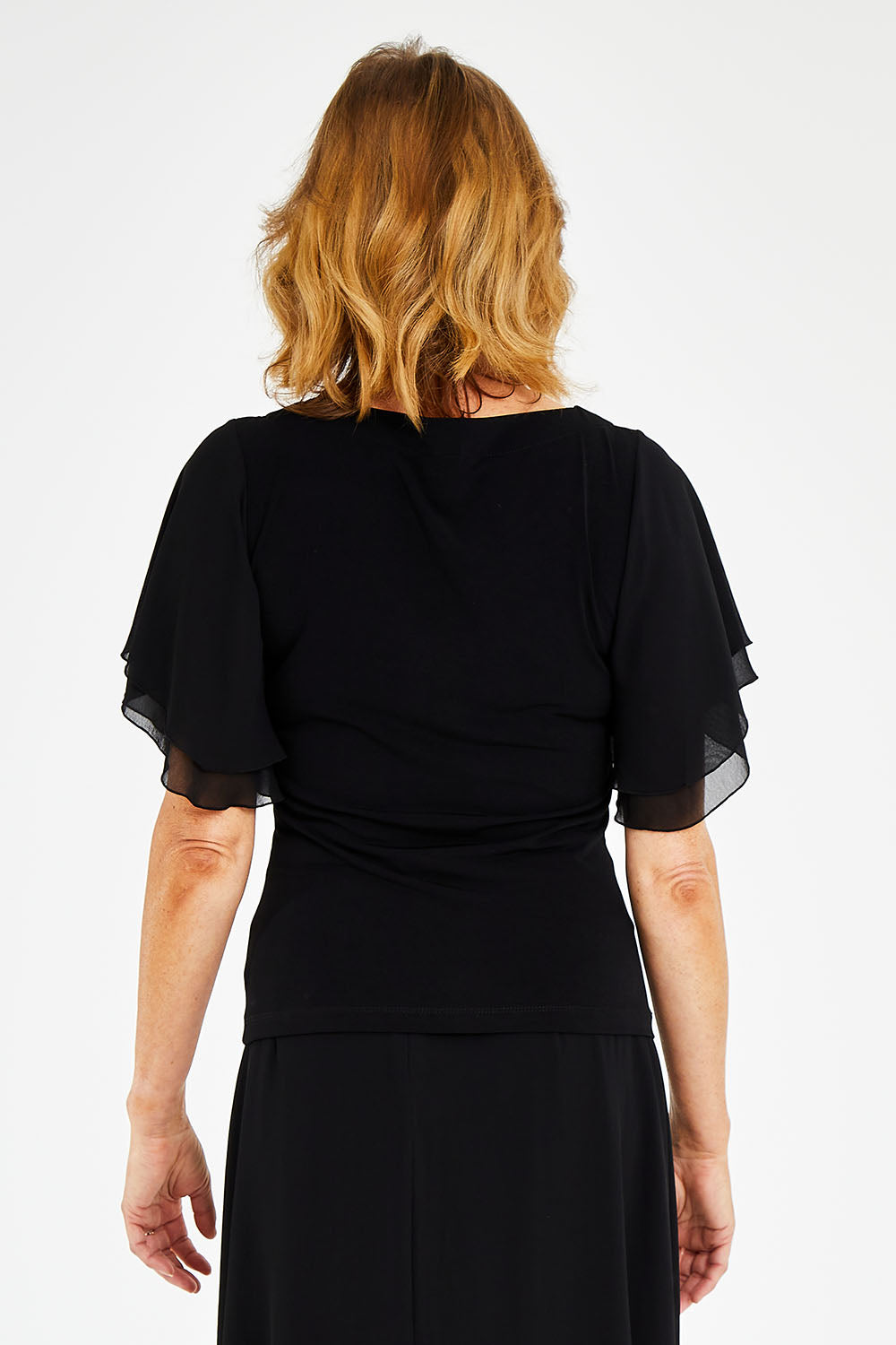 Model Naomi wearing size 10 of the Brenda Top in colour Black (Black), from the back
