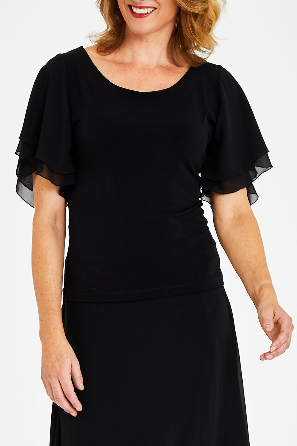 Model Naomi wearing size 10 of the Brenda Top in colour Black (Black), from the front, cropped image