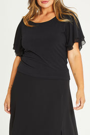Model Palatina wearing size 16 of the Brenda Top in colour Black (Black), from the front, cropped image