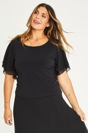Model Palatina wearing size 16 of the Brenda Top in colour Black (Black), from the front, cropped image