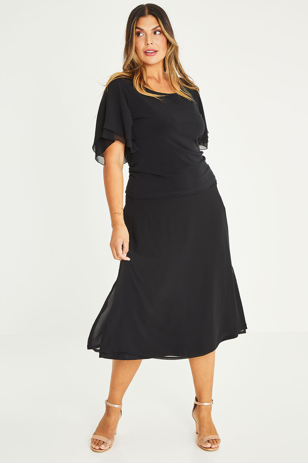 Model Palatina wearing size 16 of the Brenda Top in colour Black (Black), from the front, showing the whole outfit