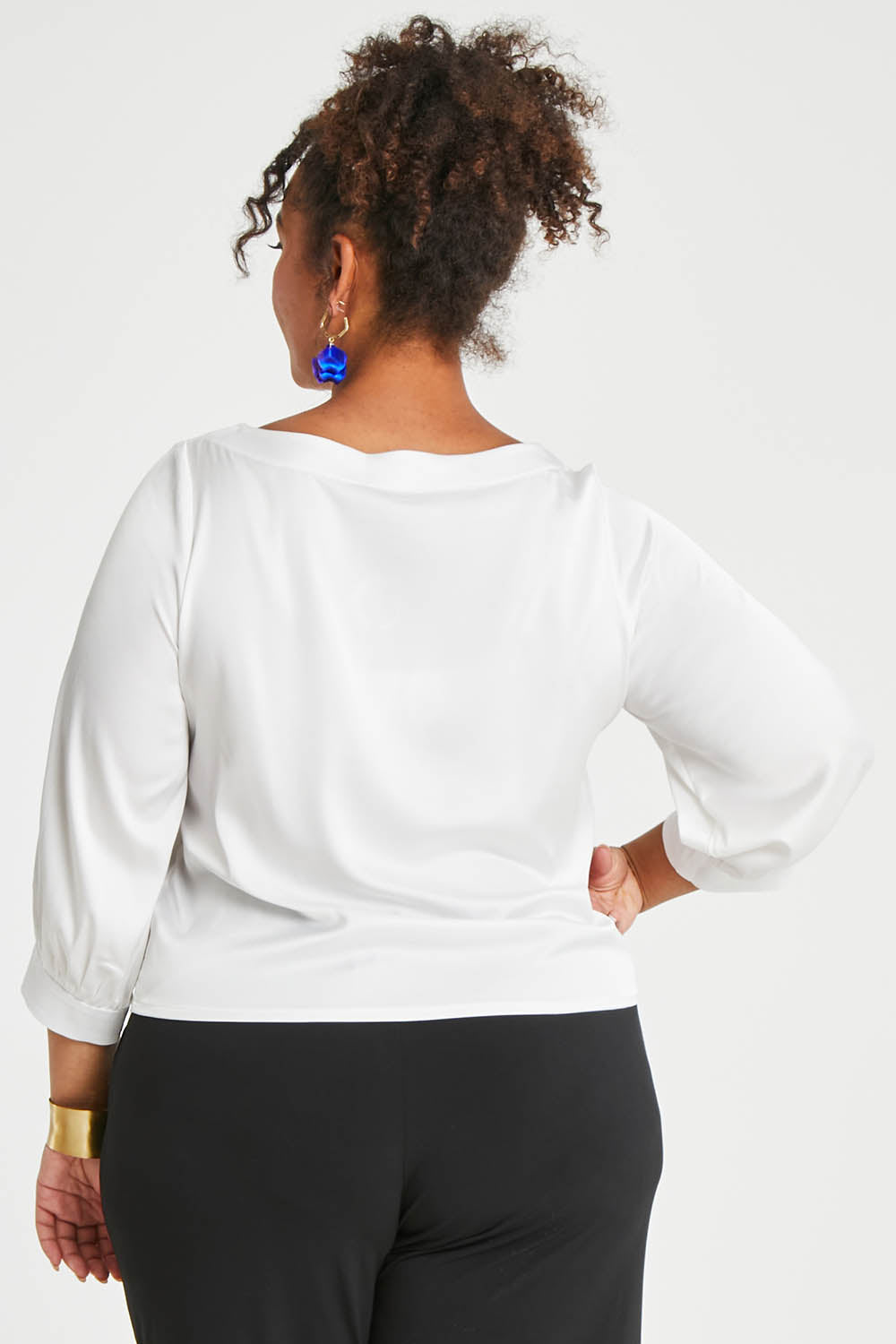 Model Alexis wearing size 16 of the Tia Blouse in colour Ivory (White), from the back