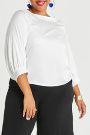 Model Alexis wearing size 16 of the Tia Blouse in colour Ivory (White), from the front, cropped image