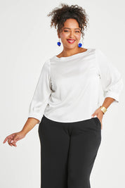 Model Alexis wearing size 16 of the Tia Blouse in colour Ivory (White), from the front, cropped image
