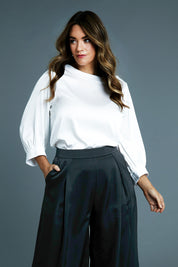 Model Laura wearing size 14 of the Tia Blouse in colour Ivory (White), from the front, showing the whole outfit