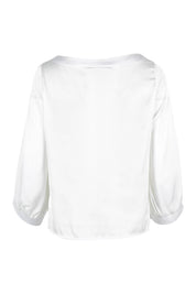 Product shot of the Tia Blouse in colour Ivory (White), from the back