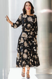 Model Andrea wearing size 10 of the Samara Skirt in colour Disbud (Black), from the front, showing the whole outfit