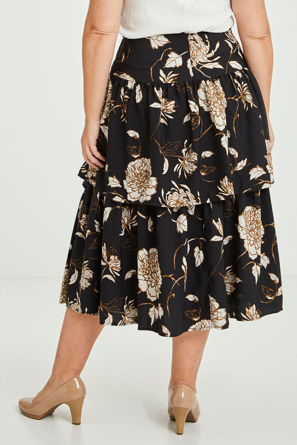 Model Fiona wearing size 16 of the Samara Skirt in colour Disbud (Black), from the back